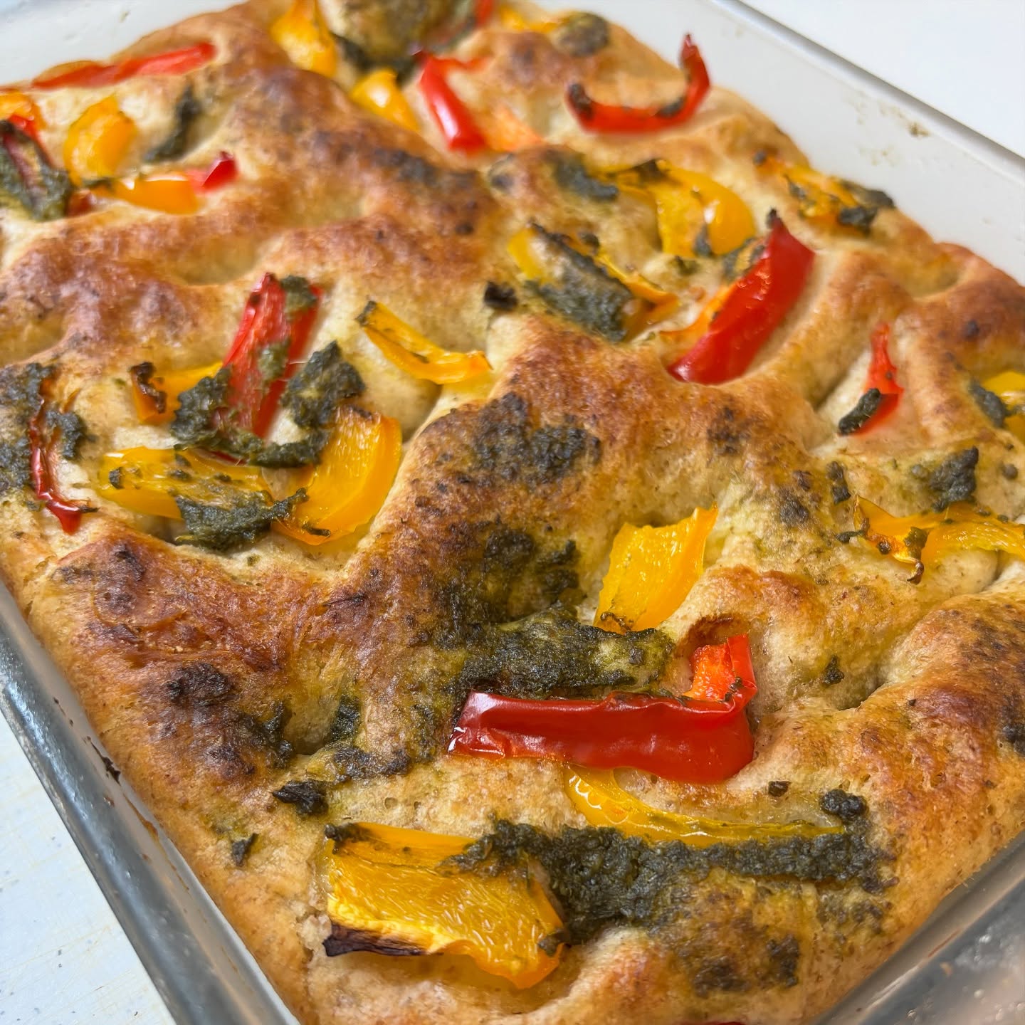 ライ麦粉のフォカッチャ今週のフォカッチャはライ麦粉を使った生地で焼き上げました。歯応えのある生地に香ばしい香りが特徴です。パプリカとルッコラジェノベーゼをのせて。今週もよろしくお願い致します。#フォカッチャ